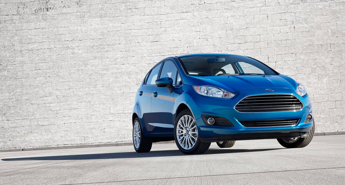 2014 Ford Fiesta 5dr: The 2014 Fiesta sports the stylish new face of Ford with a new grille, hood and tapered lines for a fun-to-drive look that makes customers want to get in and go. (11/26/2012)