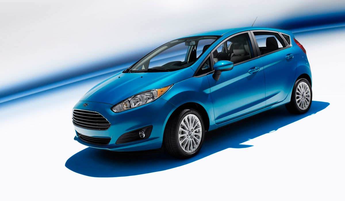 2014 Ford Fiesta 5dr: The 2014 Fiesta sports the stylish new face of Ford with a new grille, hood and tapered lines for a fun-to-drive look that makes customers want to get in and go. (11/26/2012)