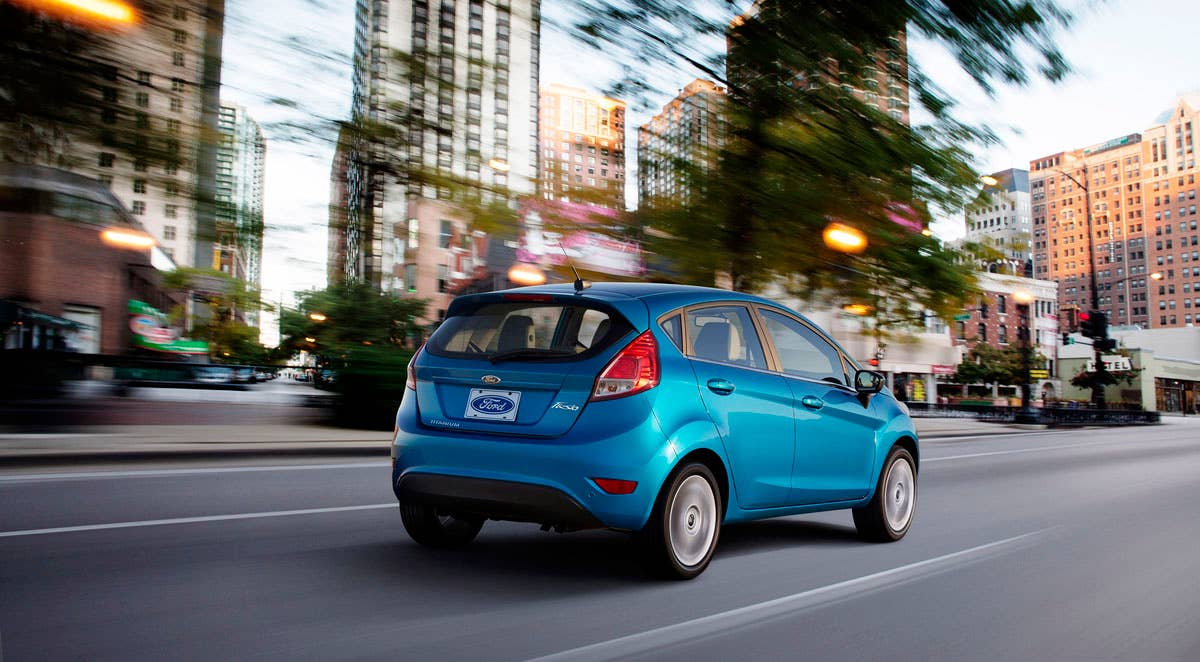 2014 Ford Fiesta 5dr: The 2014 Fiesta sports the stylish new face of Ford with a new grille, hood and tapered lines for a fun-to-drive look that makes customers want to get in and go.  (11/27/2012)