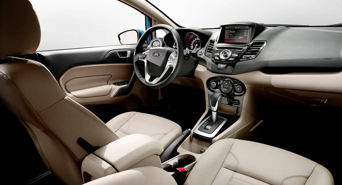 2014 Ford Fiesta 5dr: The Fiesta interior hosts one of the most comprehensive suites of in-car technologies with a cell phone-inspired dashboard and available 6.5-inch MyFord Touch screen. (11/26/2012)