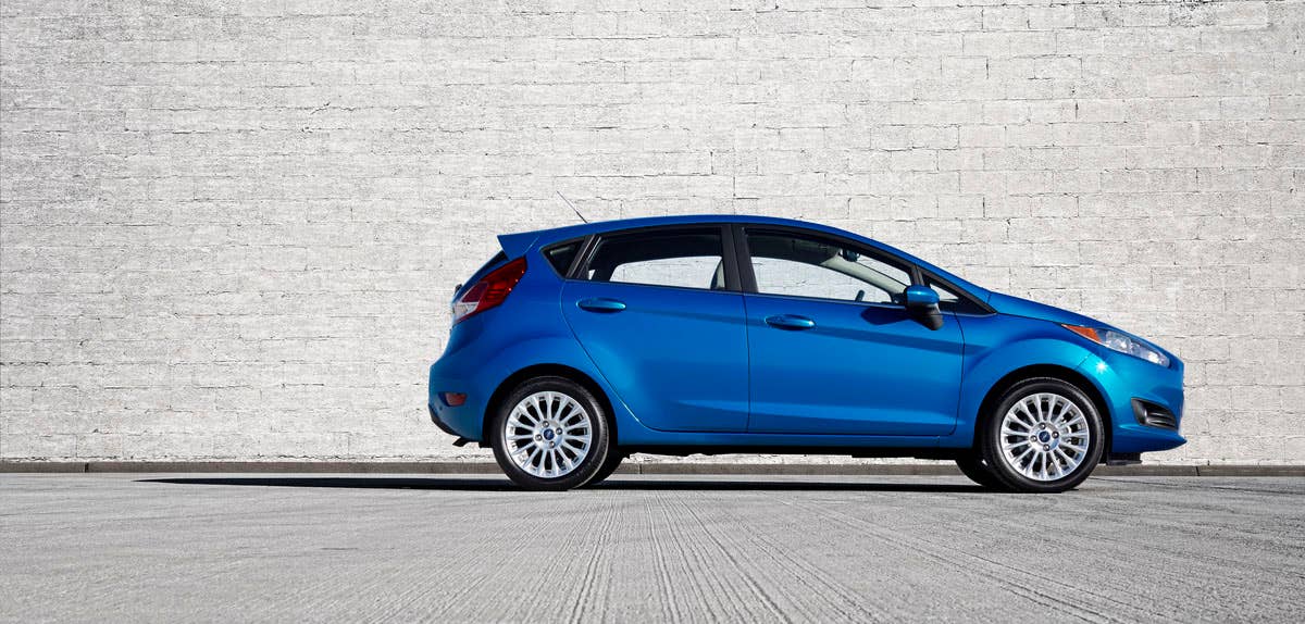 2014 Ford Fiesta 5dr: The 2014 Fiesta sports the stylish new face of Ford with a new grille, hood and tapered lines for a fun-to-drive look that makes customers want to get in and go. (11/26/2012)