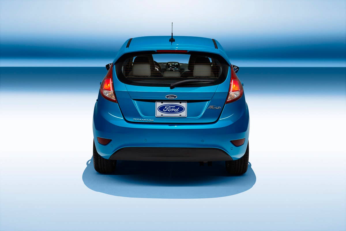 2014 Ford Fiesta 5dr: The 2014 Fiesta sports the stylish new face of Ford with a new grille, hood and tapered lines for a fun-to-drive look that makes customers want to get in and go. (11/26/2012)