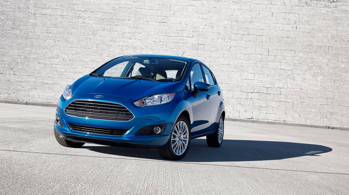 2014 Ford Fiesta 5dr: The 2014 Fiesta sports the stylish new face of Ford with a new grille, hood and tapered lines for a fun-to-drive look that makes customers want to get in and go. (11/26/2012)