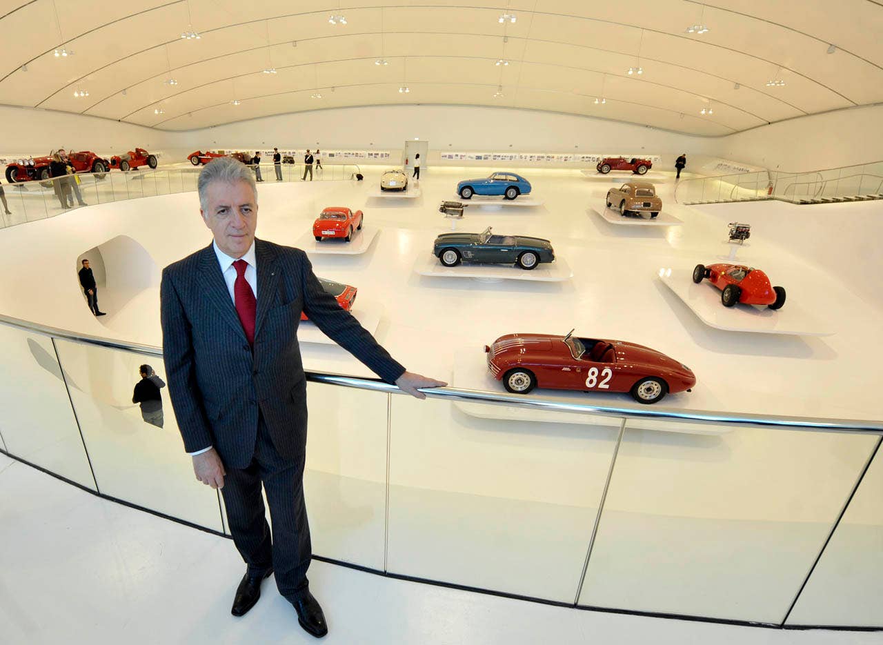 Farrari vice president Piero Ferrari poses next to a vintage Ferrari sport cars on display at the "Enzo Ferrari Casa Natale", Enzo Ferrari Family House, museum in Modena, Italy, during a media preview, Friday, March 9, 2012. The Museum, that is opening next Saturday March 10, is built in an area around the house where Enzo ferrari was born and spent the first years if his life. (AP Photo/Marco Vasini)