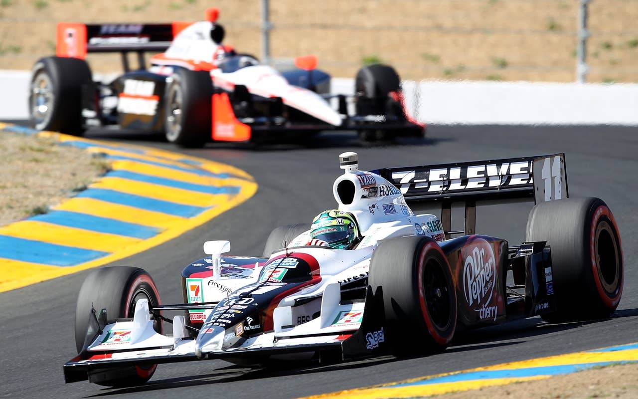 SONOMA, CA - AUGUST 22:  Tony Kanaan of Brazil, driver of the #11 Team 7-Eleven/Dr. Pepper Andretti Autosport Dallara Honda and Helio Castroneves of Brazil, driver of the #3 Team Penske Dallara Honda during practice for the IZOD IndyCar Series Grand Prix of Sonoma at Infineon Raceway on August 22, 2010 in Sonoma, California.  (Photo by Christian Petersen/Getty Images)