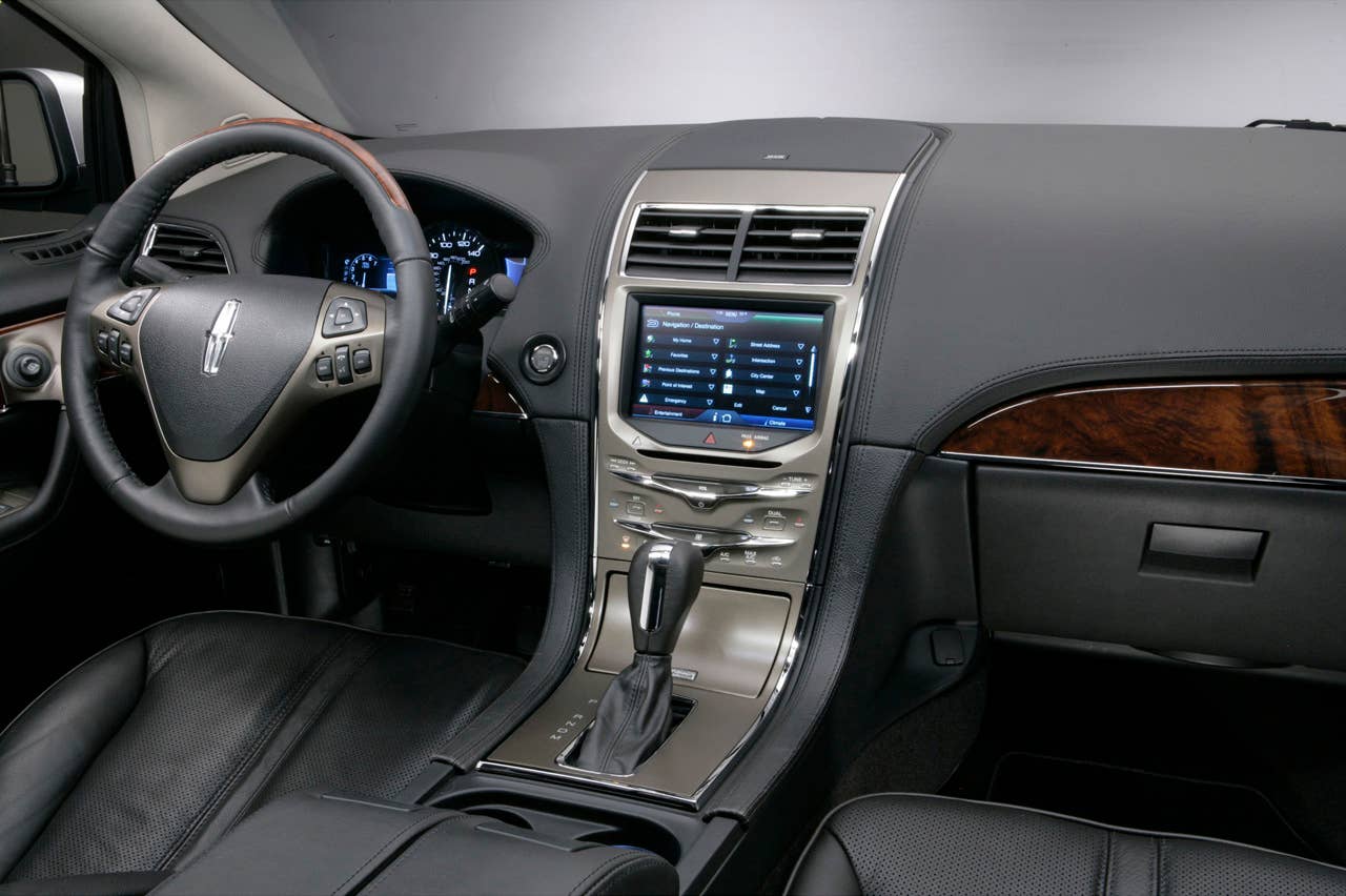 MyLincoln Touch displays information using two 4.2-inch full-color LCD screens flanking an analog speedometer and an 8-inch touch-screen LCD at the top of the center stack.
