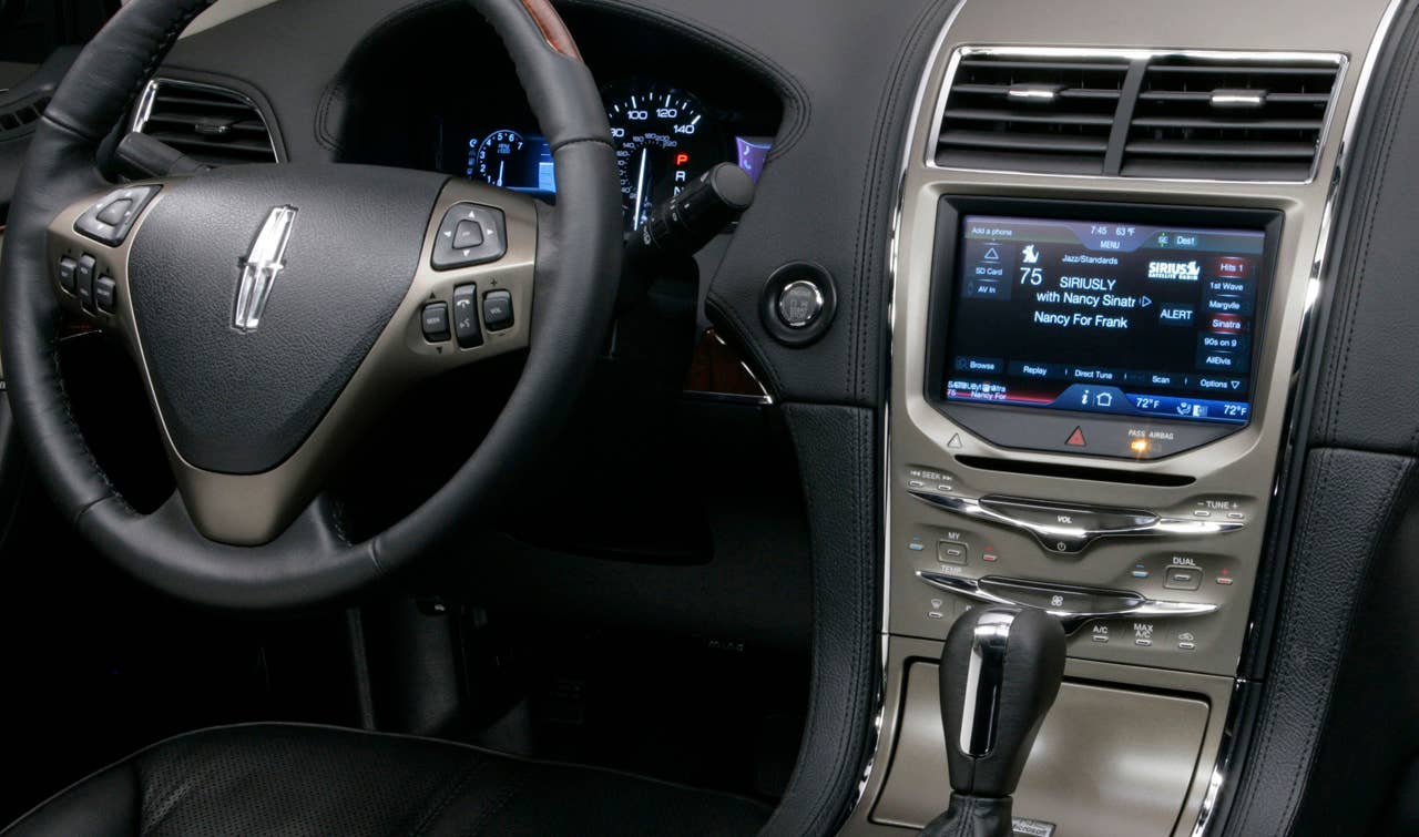 MyLincoln Touch displays information using two 4.2-inch full-color LCD screens flanking an analog speedometer and an 8-inch touch-screen LCD at the top of the center stack.