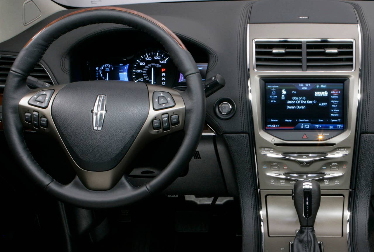 MyLincoln Touch displays information using two 4.2-inch full-color LCD screens flanking an analog speedometer and an 8-inch touch-screen LCD at the top of the center stack.