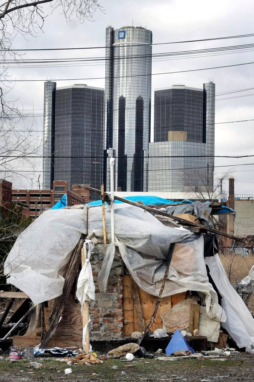 DETROIT - MARCH 30:  The General Motors world headquarters building is shown behind a homeless person's shanty March 30, 2009 in Detroit, Michigan. Yesterday the Obama administration demanded the resignation of GM Chairman and CEO Rick Wagoner as a condition of the administrations ongoing bailout plan for the struggling GM and Chrysler car companies.    (Photo by Bill Pugliano/Getty Images)