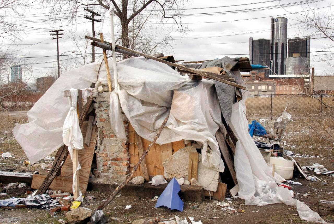 DETROIT - MARCH 30:  The General Motors world headquarters building is shown behind a homeless person's shanty March 30, 2009 in Detroit, Michigan. Yesterday the Obama administration demanded the resignation of GM Chairman and CEO Rick Wagoner as a condition of the administrations ongoing bailout plan for the struggling GM and Chrysler car companies.    (Photo by Bill Pugliano/Getty Images)