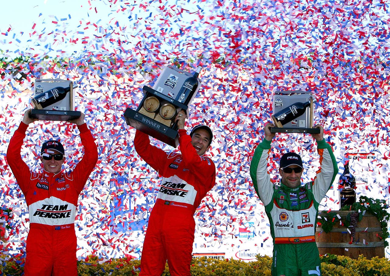 SONOMA, CA - AUGUST 24: Helio Castroneves (C) driver of the #3 Team Penske Dallara Honda celebrates second placed team mate Ryan Briscoe(L) and third placed Tony Kanaan after winning the IRL IndyCar Series PEAK Antifreeze & Motor Oil Indy Grand Prix of Sonoma County on August 24, 2008 at the Infineon Raceway in Sonoma, California. (Photo by Darrell Ingham/Getty Images)