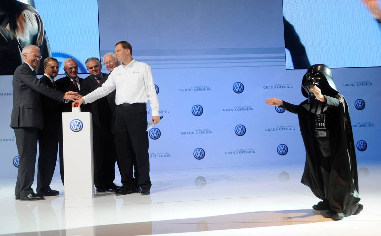 Child actor Max Page, dressed as Darth Vader, right, plays to the crowd as Volkswagen management push the red button Tuesday, May 24, 2011, at the Volkswagen Grand Opening in Chattanooga, Tenn. Volkswagen is jumping into the U.S. auto market with a new Passat that is bigger, cheaper and built domestically in hopes of breaking into the competitive midsize sedan market. (AP Photo/Billy Weeks)