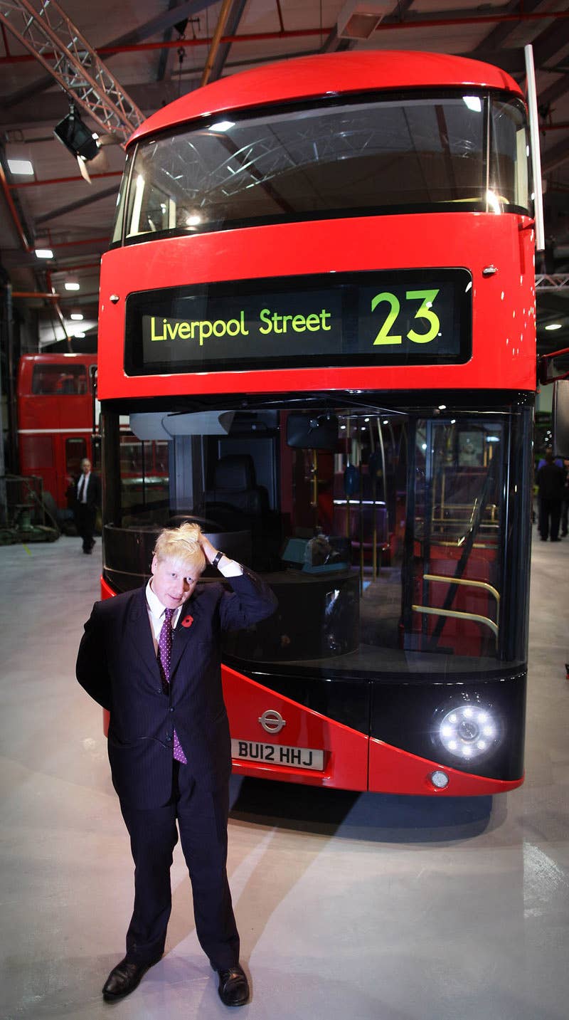 LONDON, ENGLAND - NOVEMBER 11:  Mayor of London Boris Johnson stands in front of a mock up of the New Bus for London in Acton on November 11, 2010 in London, England. The new bus design mimics some of the features of the iconic red London Routemaster bus and is scheduled to come into service in 2012. The original Routemaster was introduced in 1956 and a number of them are still in use on heritage routes in London, following their withdrawal from regular routes in 2005.  (Photo by Peter Macdiarmid/Getty Images)