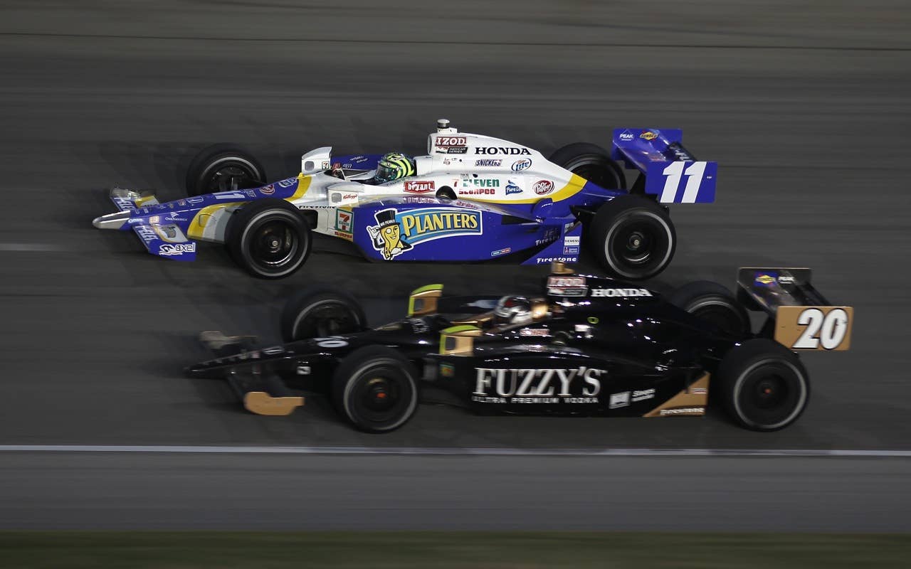 CHICAGO - AUGUST 28:  Ed Carpenter, driver of the #20 Panther/Vision/Fuzzy's Vodka Dallara Honda, races Tony Kanaan of Brazil, driver of the #11 Team 7-Eleven/Planter Andretti Autosport Dallara Honda, during the IndyCar Series PEAK Antifreeze and Motor Oil Indy 300 at Chicagoland Speedway on August 28, 2010 in Chicago, Illinois.  (Photo by Streeter Lecka/Getty Images) *** Local Caption *** Ed Carpenter;Tony Kanaan