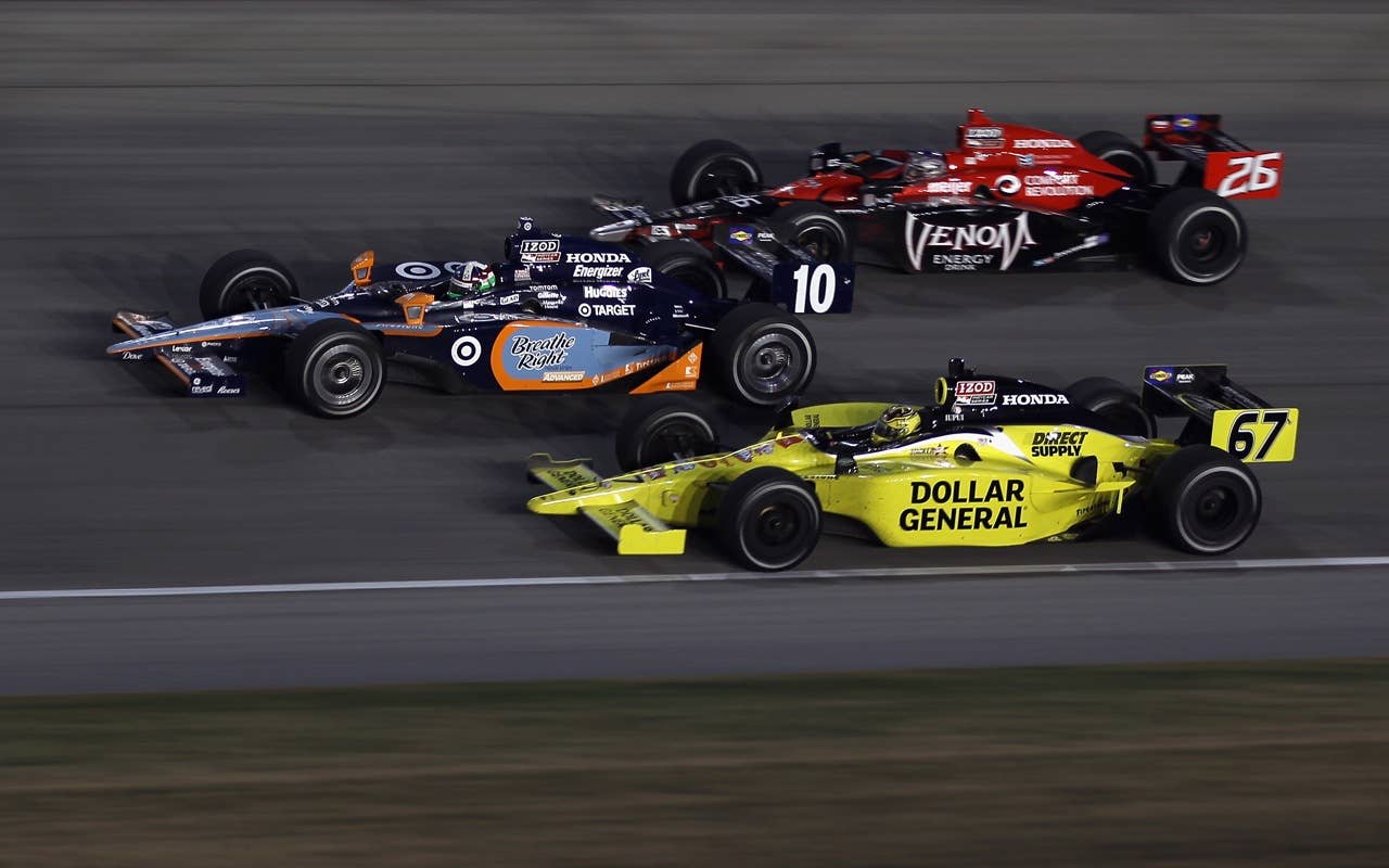 CHICAGO - AUGUST 28:  Dario Franchitti of Scotland, driver of the #10 Breathe Right Target Chip Ganassi Racing Dallara Honda, leads Sarah Fisher, driver of the #67 Dollar General Dallara Honda, and Marco Andretti, driver of the #26 Team Venom Energy Andretti Autosport Dallara Honda, during the IndyCar Series PEAK Antifreeze and Motor Oil Indy 300 at Chicagoland Speedway on August 28, 2010 in Chicago, Illinois.  (Photo by Streeter Lecka/Getty Images) *** Local Caption *** Dario Franchitti;Sarah Fisher;Marco Andretti