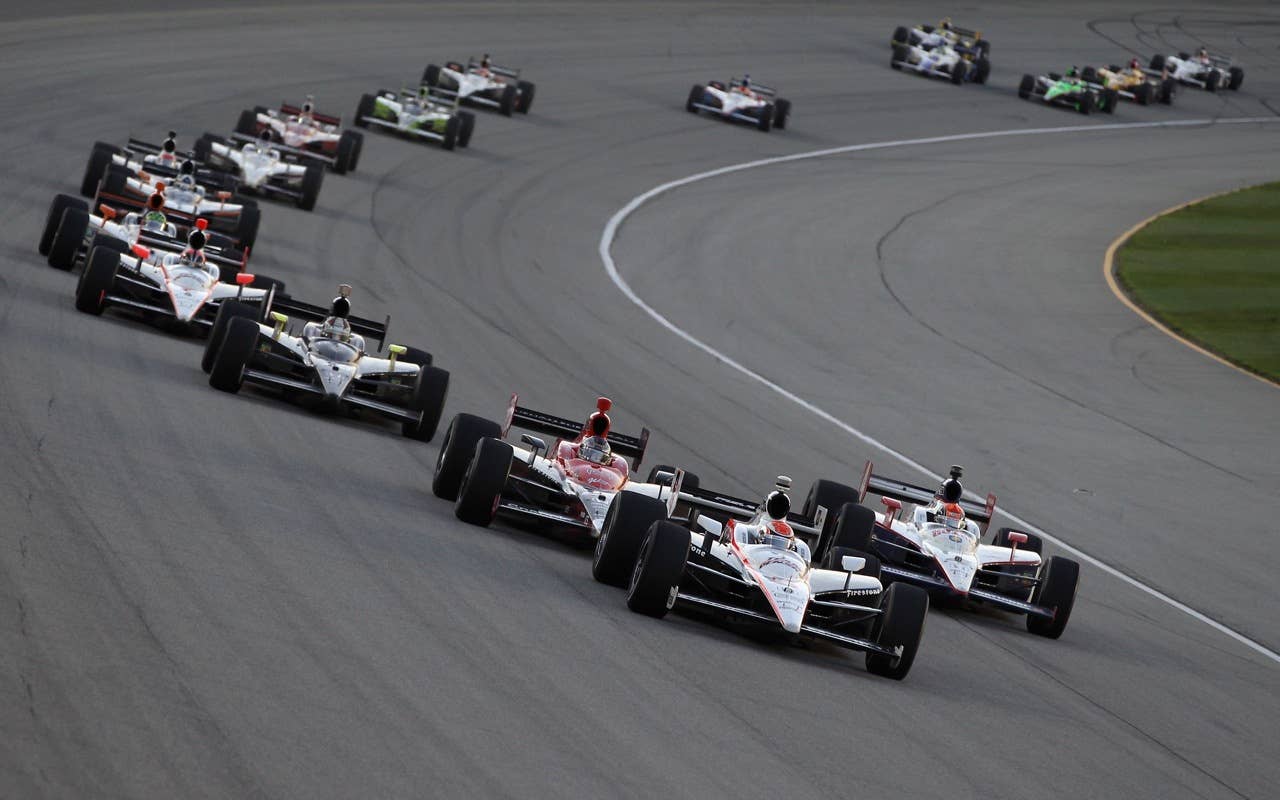CHICAGO - AUGUST 28:  Ryan Briscoe, driver of the #6 Team Penske Dallara Honda, leads Dan Wheldon of England, driver of the #4 National Guard Panther Racing Dallara Honda, and Marco Andretti, driver of the #26 Team Venom Energy Andretti Autosport Dallara Honda, during the IndyCar Series PEAK Antifreeze and Motor Oil Indy 300 at Chicagoland Speedway on August 28, 2010 in Chicago, Illinois.  (Photo by Streeter Lecka/Getty Images) *** Local Caption *** Ryan Briscoe;Dan Wheldon;Marco Andretti