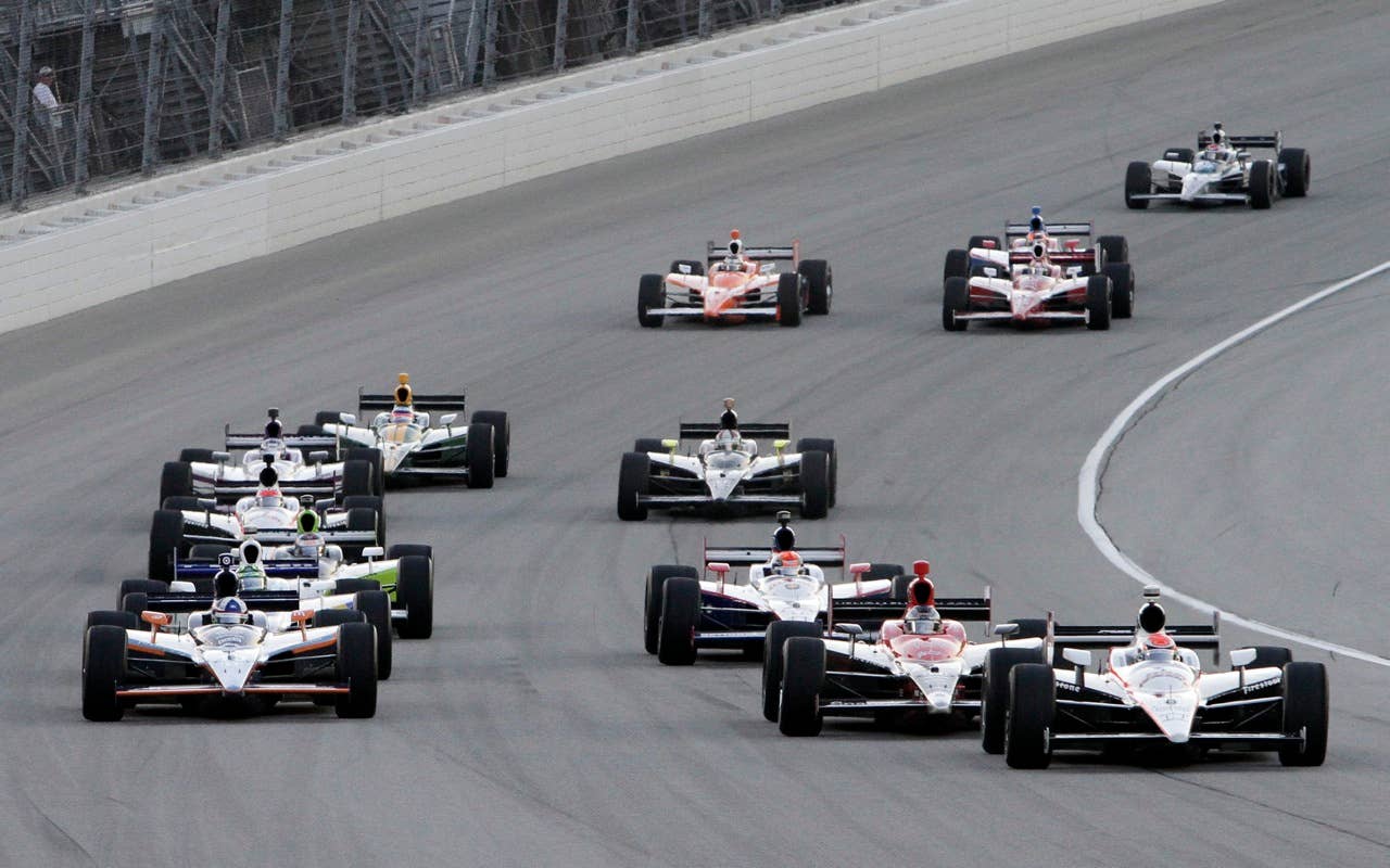 Ryan Briscoe, right, leads during  the Peak Antifreeze and Motor Oil Indy 300 auto race at ChicagoLand Speedway in Joliet, Ill., Saturday, Aug. 28, 2010. (AP Photo/Nam Y. Huh)