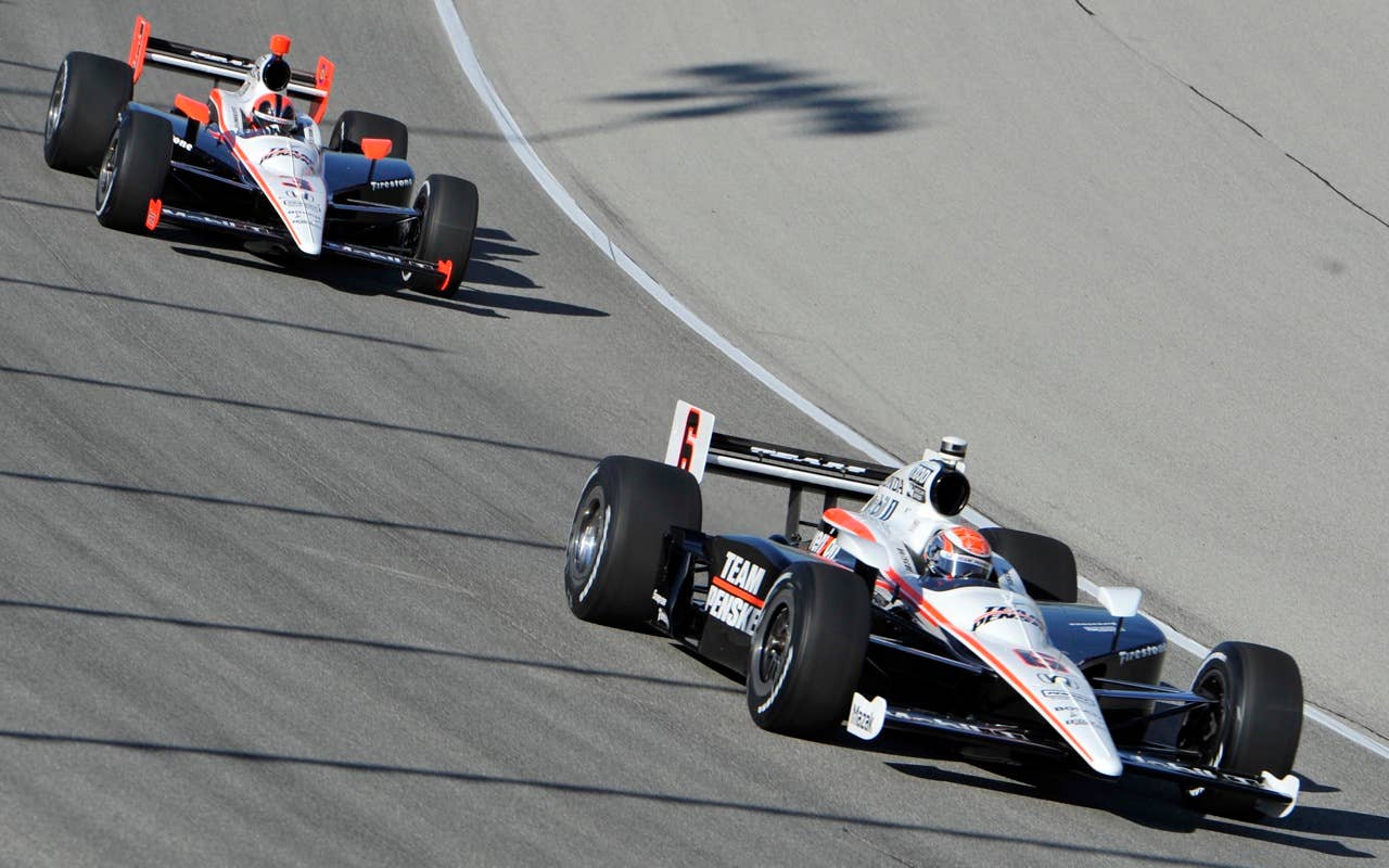 Ryan Briscoe, Auckland, New Zeland, leads Helio Castroneves through a turing during practice for the Peak Antifreeze and Motor Oil Indy 300  at Chicagoland Speedway in Joliet, Ill., Friday, Aug. 27, 2010. Briscoe won the pole position. (AP Photo/Warren Wimmer)