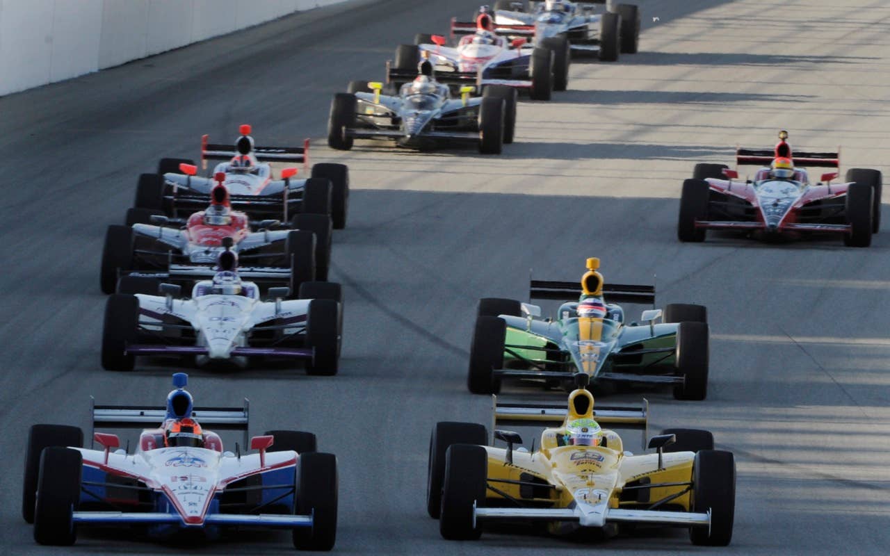 Jay Howard, right, Basildon, England, and Alex Lloyd, left, Manchester, Englend, lead through a turn during practice for the Peak Antifreeze and Motor Oil Indy 300 auto race at Chicagoland Speedway in Joliet, Ill., Friday, Aug. 27, 2010, (AP Photo/Warren Wimmer)
