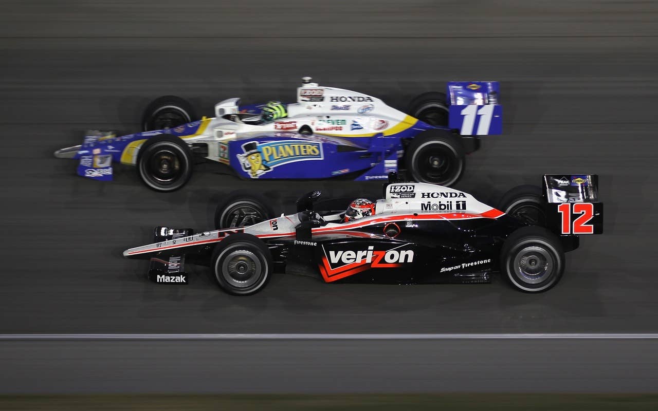 CHICAGO - AUGUST 28:  Will Power of Australia, driver of the #12 Verizon Team Penske Dallara Honda, races Tony Kanaan of Brazil, driver of the #11 Team 7-Eleven/Planter Andretti Autosport Dallara Honda, during the IndyCar Series PEAK Antifreeze and Motor Oil Indy 300 at Chicagoland Speedway on August 28, 2010 in Chicago, Illinois.  (Photo by Streeter Lecka/Getty Images) *** Local Caption *** Will Power;Tony Kanaan