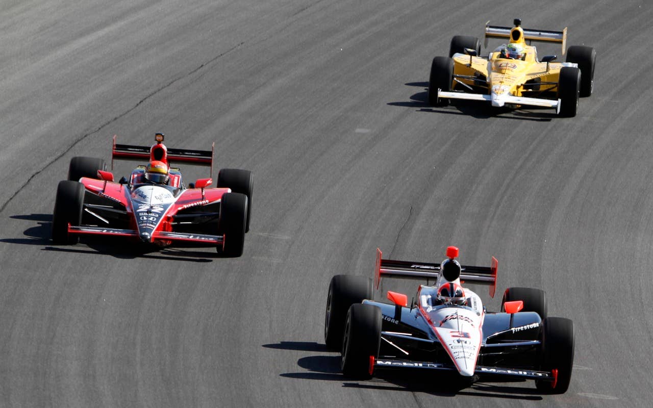 Helio Castroneves (3) of Brazil, Justin Wilson (22) of England, and Jay Howard, right, of England, drive their car during Indy Car final practice for the Peak Antifreeze and Motor Oil Indy 300 auto race at ChicagoLand Speedway in Joliet, Ill., Friday, Aug. 27, 2010. (AP Photo/Nam Y. Huh)