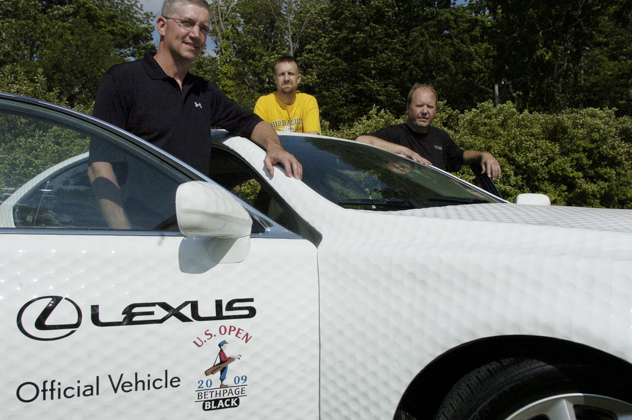 From left Brad Smith, Matt and Rick Davis stand with a Lexus LS 460L Tuesday afternoon that they retrofitted with golf ball style paneling for Lexus to be the Official Vehicle at this weekend's U.S. Open. The trio took 12 weeks to design the dimple panels that were taken from the concept of Smith's golf ball mailbox. GAVIN JACKSON/The Lima News