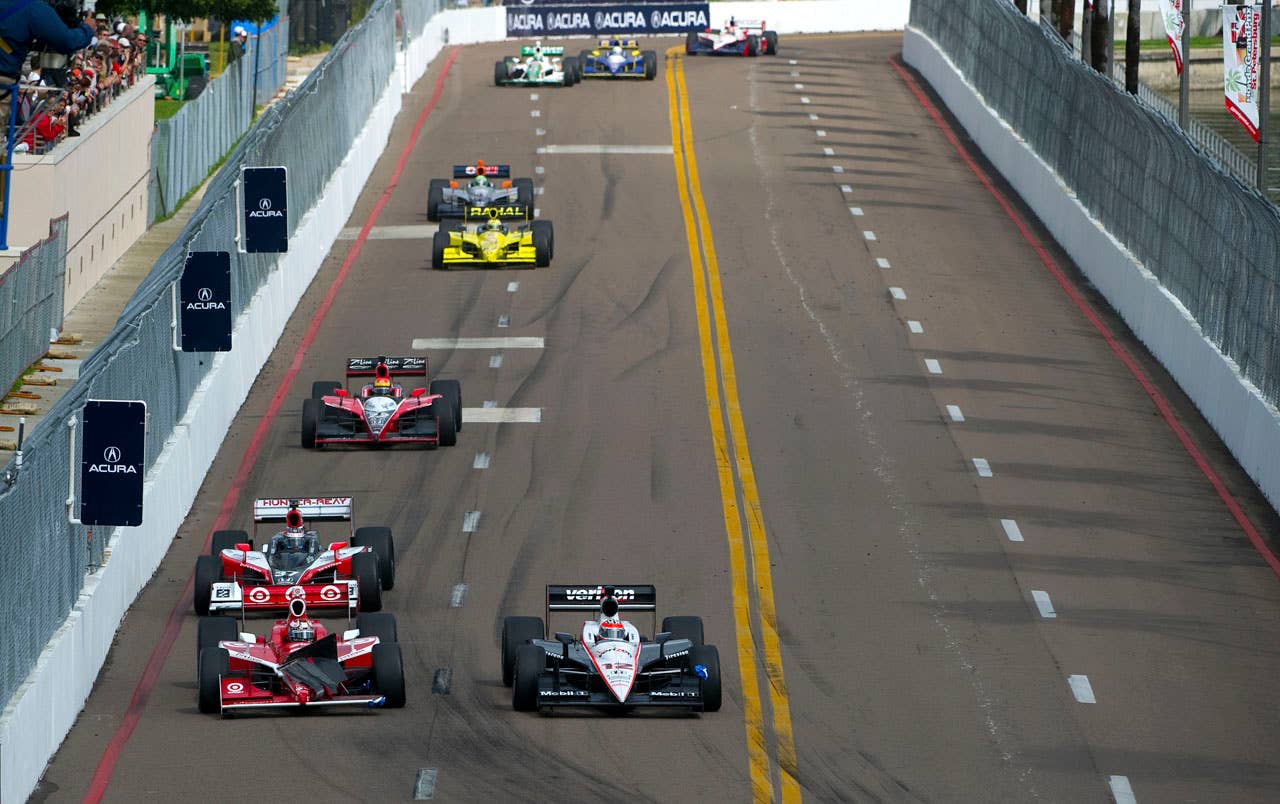 ST. PETERSBURG, FL - MARCH 29:  Will Power driver of the #12 Verizon Team Penske Dallara Honda leads a pack of cars as Scott Dixon driver of the #9 Target Chip Ganassi Dallara Honda drives with a broken nose cone during the IndyCar Series Honda Grand Prix of St.Petersburg on March 29, 2010 on the streets of St. Petersburg, Florida. (Photo by Robert Laberge/Getty Images) *** Local Caption *** Scott Dixon;Will Power