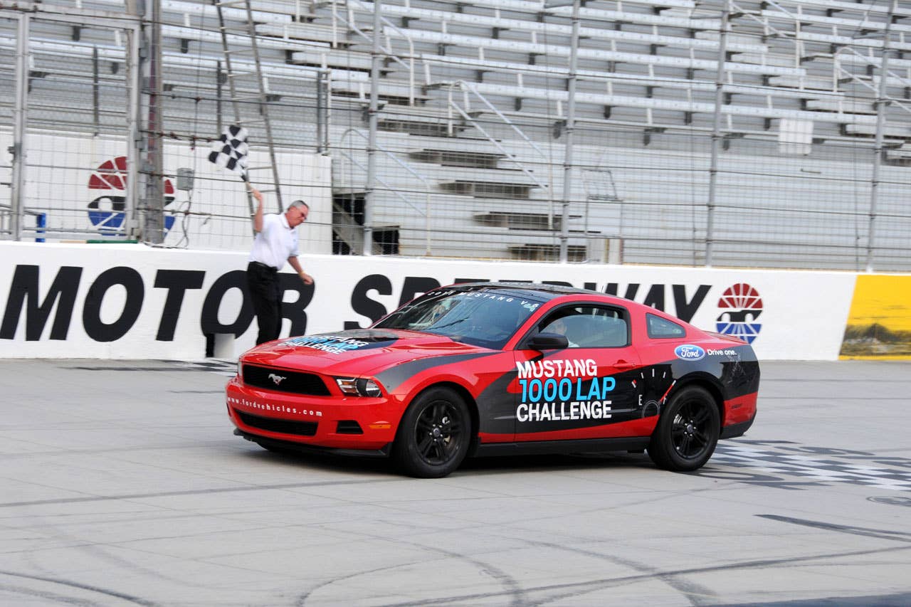 06/23/10 Bristol, Tn. - Tim Duerr, Ford Racing Marketing Manager, throws the checkered flag as NASCAR driver David Ragan crosses the start/finish line completeing the one-thousandth lap in the Mustang 1000 Lap Challenge in which a 2011 Mustang V6 attempted to complete 1000 laps or 533 miles at Bristol Motor Speedway on a single tank of fuel.  With a quarter tank of fuel remaining on the one-thousandth lap, the decision was made to continue running the V6 Mustang until it ran out fuel.   2010, Paul Webb