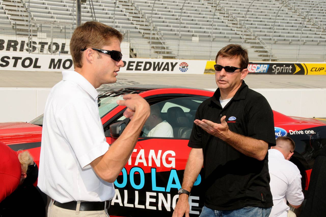 06/23/10 Bristol, Tn. - Ford NASCAR driver David Ragan talks with Ford Mustang engineer and fellow Mustang Challenge driver Tom Barnes during a brief driver change pit stop during the Mustang 1000 Lap Challenge, an attempt to drive more than 1,000 laps, or 533 miles, at Bristol Motor Speedway on a single tank of fuel.    2010, Paul Webb