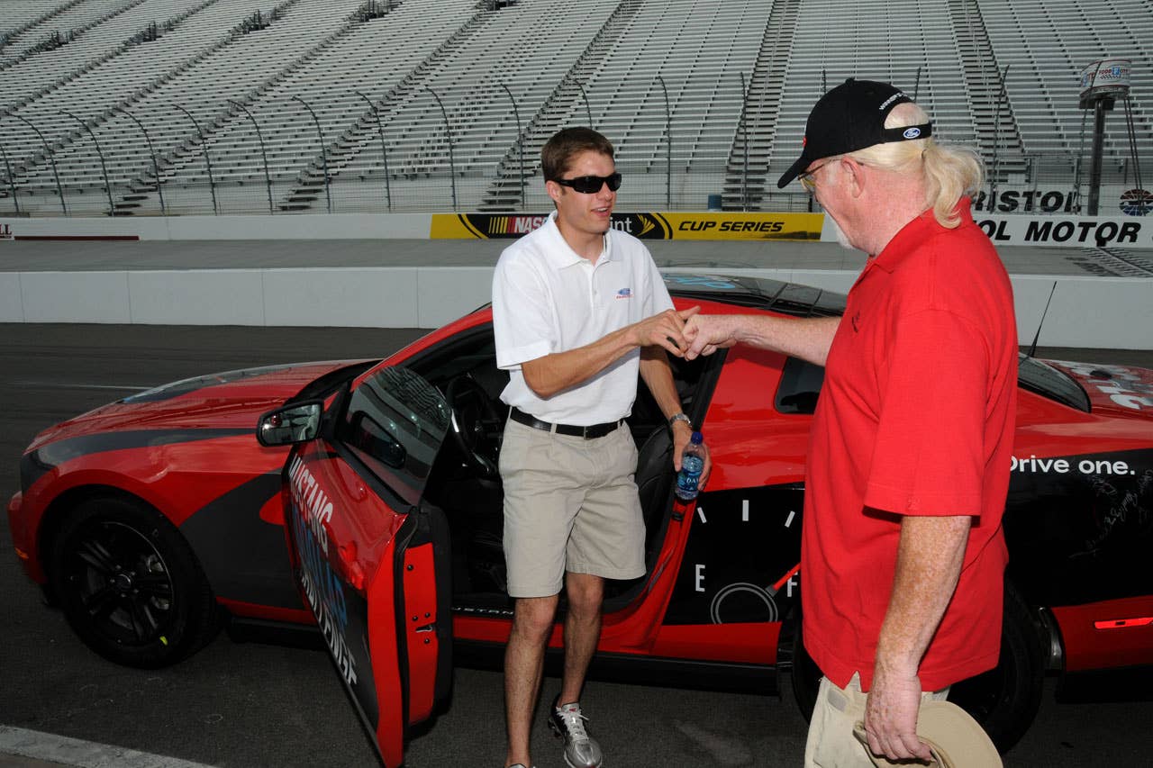 06/23/10 Bristol, Tn. - Ford NASCAR driver David Ragan hands over the 2011 Mustang V6 to Ford Mustang engineer Carl Ek during the Mustang 1000 Lap Challenge, an attempt to drive more than 1,000 laps, or 533 miles, at Bristol Motor Speedway on a single tank of fuel.    2010, Paul Webb