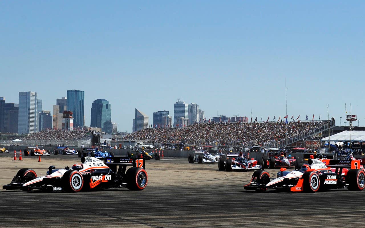 Will Power, left, of Australia, and teammate Helio Castroneves, of Brazil, lead the pack during the start of IndyCar Series' Honda Indy Edmonton auto race in Edmonton, Alberta, Sunday, July 25, 2010. (AP Photo/The Canadian Press, John Ulan)