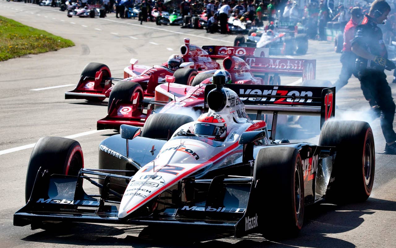 Australia's Will Power, foreground, leads Scotland's Dario Franchitti, center, and New Zealand's Scott Dixon out of the pits during a warmup session prior to the start of Honda Indy Edmonton auto race, in Edmonton, Alberta, Sunday, July 25, 2010. (AP Photo/The Canadian Press,Jeff McIntosh)