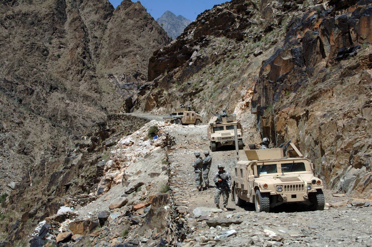 Soldiers of the Kalagush Provincial Reconstruction Team prepare to walk to the remote village of Balik during a patrol in the rugged Titin Valley in the Nuristan province of Afghanistan on June 14, 2007.  DoD photo by Staff Sgt. Michael Bracken, U.S. Army.  (Released)