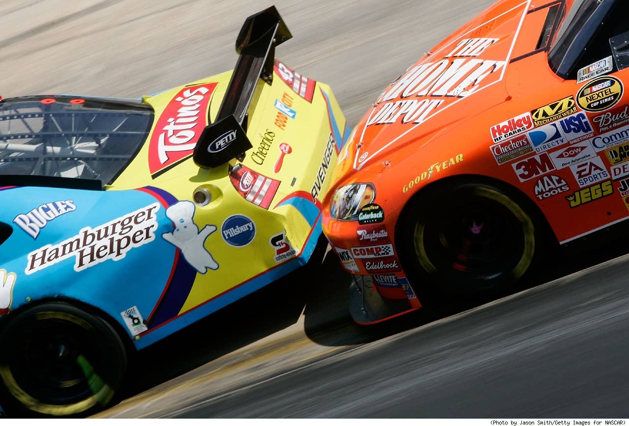 Tony Stewart, driver of the #20 The Home Depot Chevrolet, pushes Bobby Labonte, driver of the #43 Betty Crocker Dodge, during the NASCAR Nextel Cup Series Food City 500 at Bristol Motor Speedway on March 25, 2007 in Bristol, Tennessee.