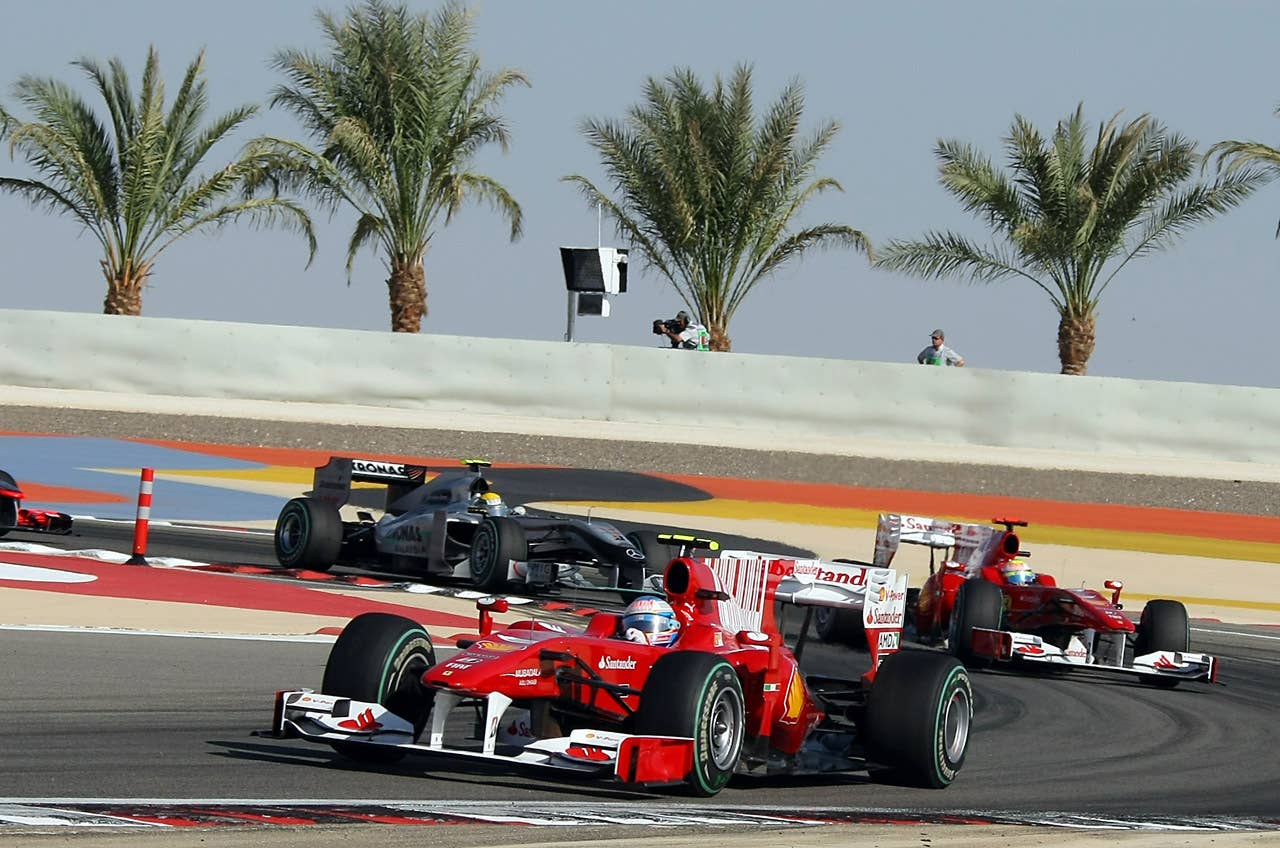 Ferrari's Spanish driver Fernando Alonso drives ahead of Ferrari's Brazilian driver Felipe Massa at the Bahrain international circuit on March 14, 2010 in Manama, during the Bahrain Formula One Grand Prix.            AFP PHOTO / KARIM SAHIB (Photo credit should read KARIM SAHIB/AFP/Getty Images)