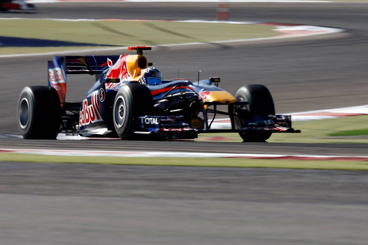 Red Bull's German driver Sebastian Vettel drives at the Bahrain international circuit on March 14, 2010 in Manama. The season-opening Bahrain Grand Prix, the first round of the 60th anniversary year of the Formula One World Championship, got off to a smooth start at the Sakhir circuit.    AFP PHOTO / GUILLAUME BAPTISTE (Photo credit should read GUILLAUME BAPTISTE/AFP/Getty Images)