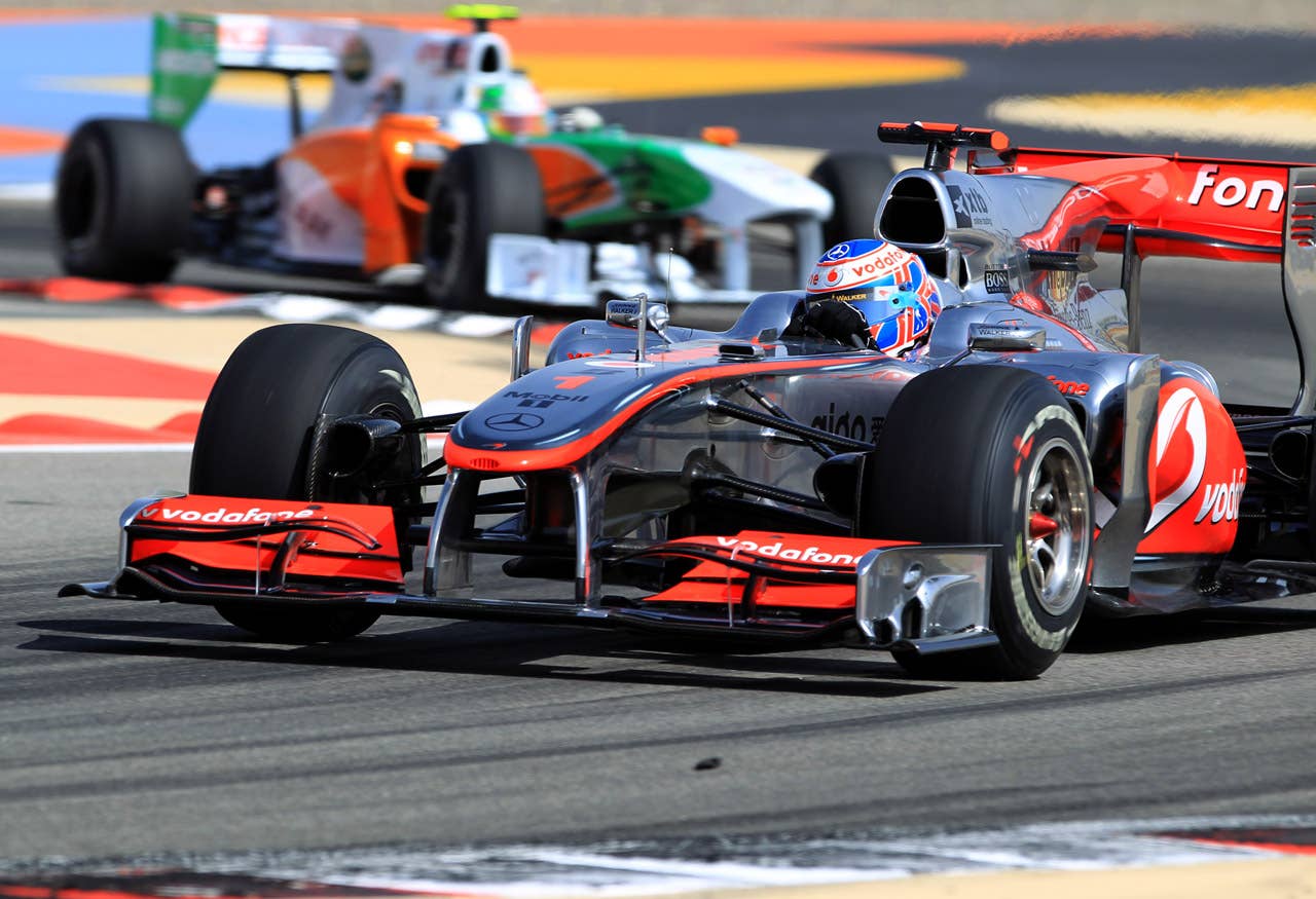 McLaren Mercedes' British driver Jenson Button drives ahead Force India's Italian driver Vitantonio Liuzzi at the Bahrain international circuit on March 13, 2010 in Manama, during the qualifying session of the Bahrain Formula One Grand Prix.        AFP PHOTO / KHALED DESOUKI (Photo credit should read KHALED DESOUKI/AFP/Getty Images)