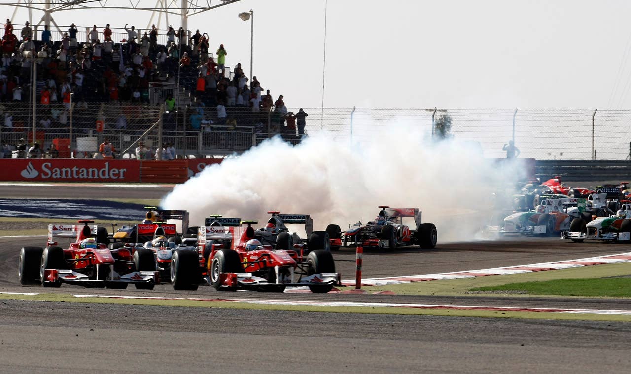 Ferrari's Spanish driver Fernando Alonso drives ahead of Ferrari's Brazilian driver Felipe Massa at the Bahrain international circuit on March 14, 2010 in Manama. The season-opening Bahrain Grand Prix, the first round of the 60th anniversary year of the Formula One World Championship, got off to a smooth start at the Sakhir circuit.    AFP PHOTO / GUILLAUME BAPTISTE (Photo credit should read GUILLAUME BAPTISTE/AFP/Getty Images)