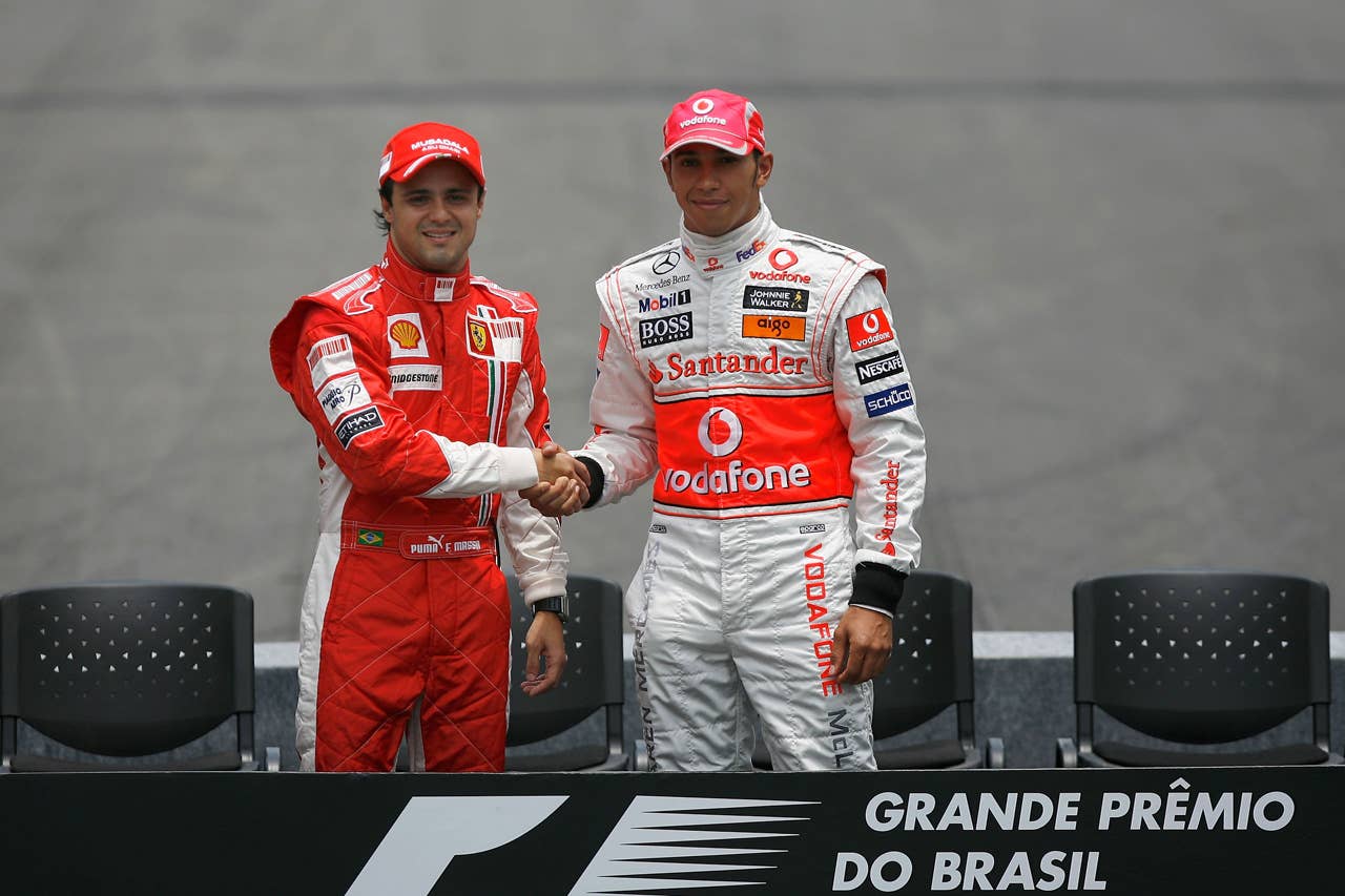 SAO PAULO, BRAZIL - NOVEMBER 02: Championship rivals Felipe Massa (L) of Brazil and Ferrari and Lewis Hamilton (R) of Great Britain and McLaren Mercedes shake hands at the drivers end of year photo session prior to the Brazilian Formula One Grand Prix at the Interlagos Circuit on November 2, 2008 in Sao Paulo, Brazil. (Photo by Paul Gilham/Getty Images)