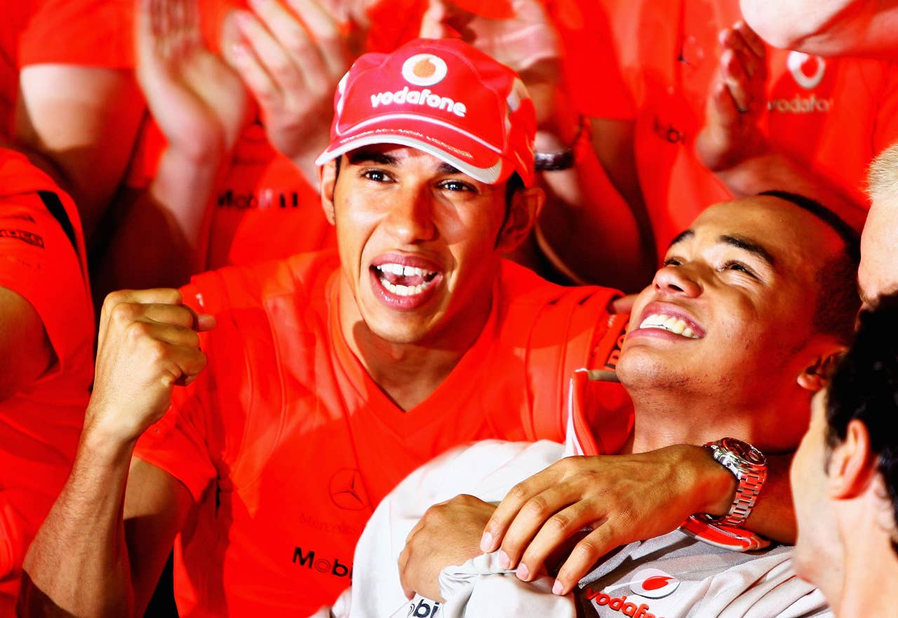 SAO PAULO, BRAZIL - NOVEMBER 02: New Formula One World Champion Lewis Hamilton of Great Britain and McLaren Mercedes (L) celebrates with his half-brother Nick Hamilton (R) following the Brazilian Formula One Grand Prix at the Interlagos Circuit on November 2, 2008 in Sao Paulo, Brazil. (Photo by Clive Mason/Getty Images)