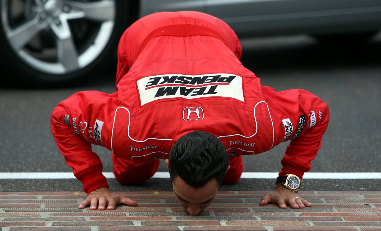 INDIANAPOLIS - MAY 24: Helio Castroneves, driver of the #3 Team Penske Dallara Honda, celebrates his victory by kissing the yard of bricks during the IRL IndyCar Series 93rd running of the Indianapolis 500 on May 24, 2009 at the Indianapolis Motor Speedway in Indianapolis, Indiana. (Donald Miralle/Getty Images )