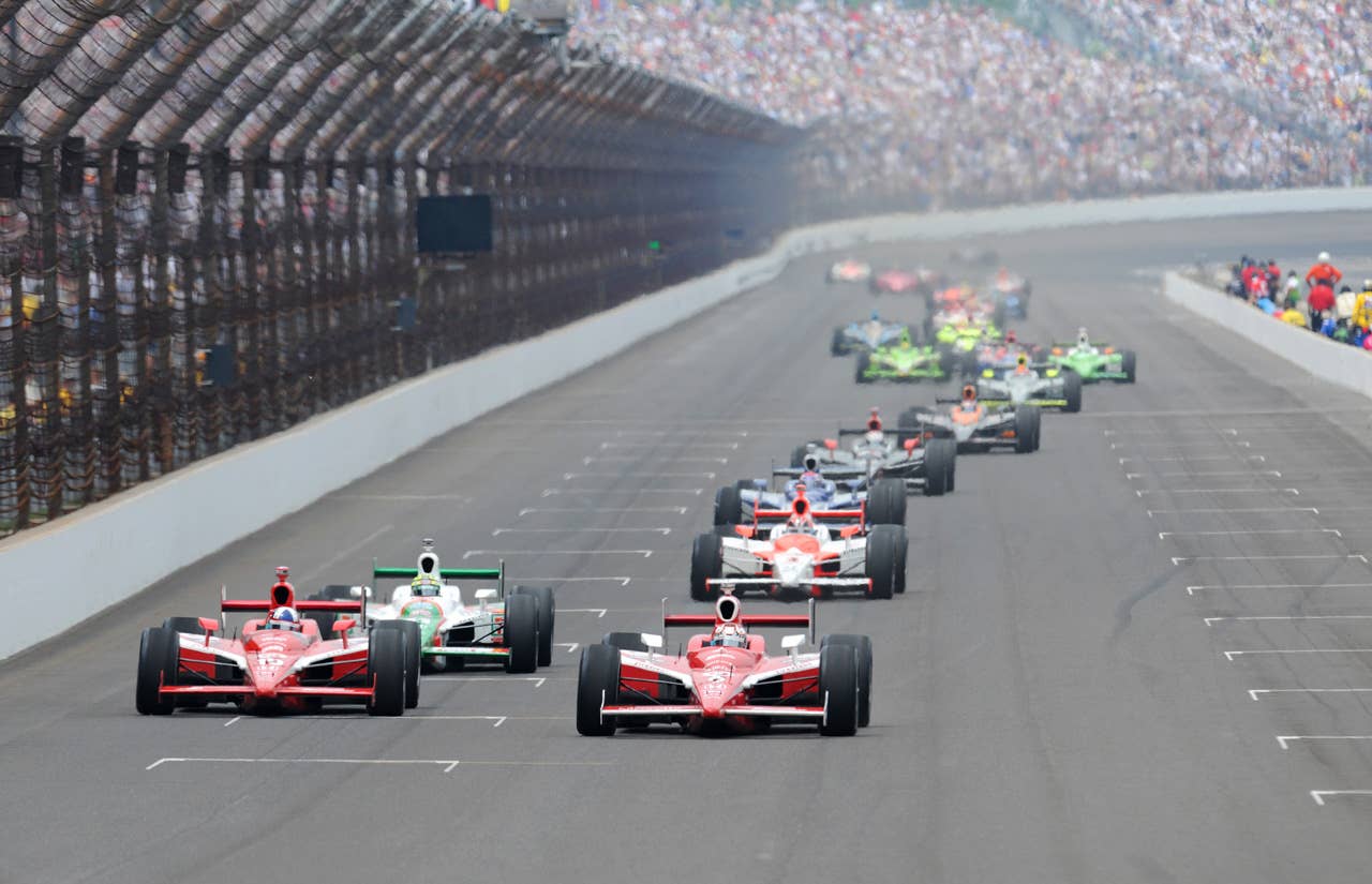 INDIANAPOLIS - MAY 24: Scott Dixon (right) driver of the #9 Target Chip Ganassi Dallara Honda leads his teamate Dario Franchitti and the rest of the field during the IRL IndyCar Series 93rd running of the Indianapolis 500 at the Indianapolis Motor Speedway on May 24, 2009 in Indianapolis, Indiana. (Photo by Robert Laberge/Getty Images)