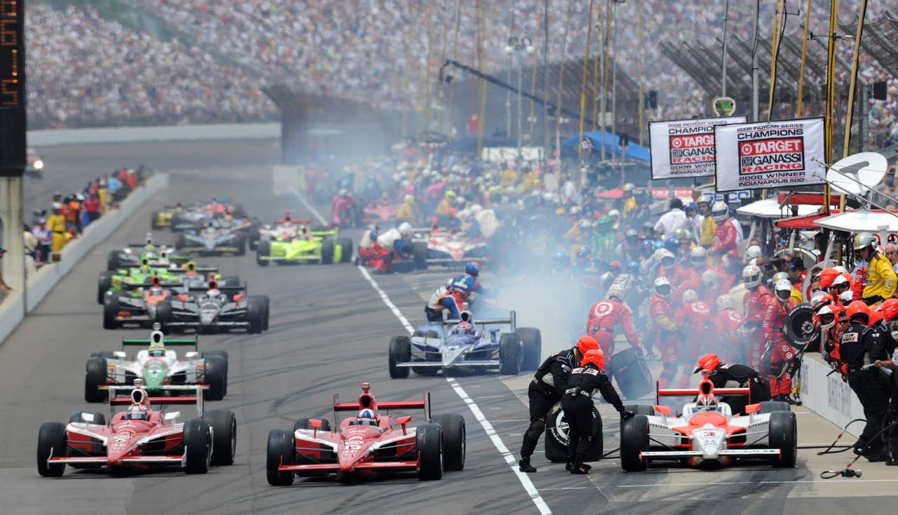 INDIANAPOLIS - MAY 24: Scott Dixon (left) driver of the #9 Target Chip Ganassi Dallara Honda and his teamate Dario Franchitti come out of the pits ahead of Helio Castroneves during the IRL IndyCar Series 93rd running of the Indianapolis 500 at the Indianapolis Motor Speedway on May 24, 2009 in Indianapolis, Indiana. (Photo by Robert Laberge/Getty Images)