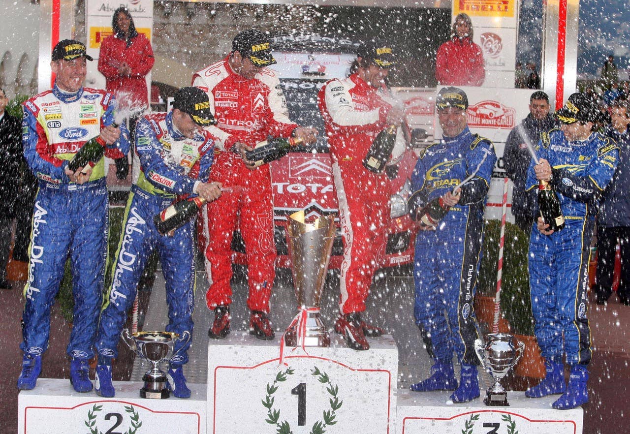 Finland Mikko Hirvonen and his co-driver Jarmo Lehtinen, Monaco's Daniel Helena and French driver Sebastien Loeb and Belgium co-driver Stephane Prevot and Australian driver Chris Atkinson celebrate on the podium of the 76th Monte-Carlo rally, 27 January 2008 in Monaco. Loeb won the event ahead of Finnish Mikko Hirvonen and Australian Chris Atkinson.