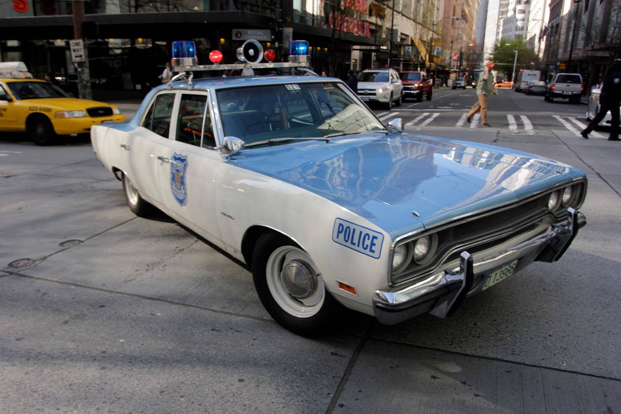In this image taken Tuesday, April 23, 2013, a 1970 Plymouth Satellite police cruiser is parked on a downtown Seattle street while a Seattle Police Department officer Jim Ritter responds to a call. Ritter uses the vintage car as his everyday car and for community outreach for the Seattle Police Department. (AP Photo/Manuel Valdes)