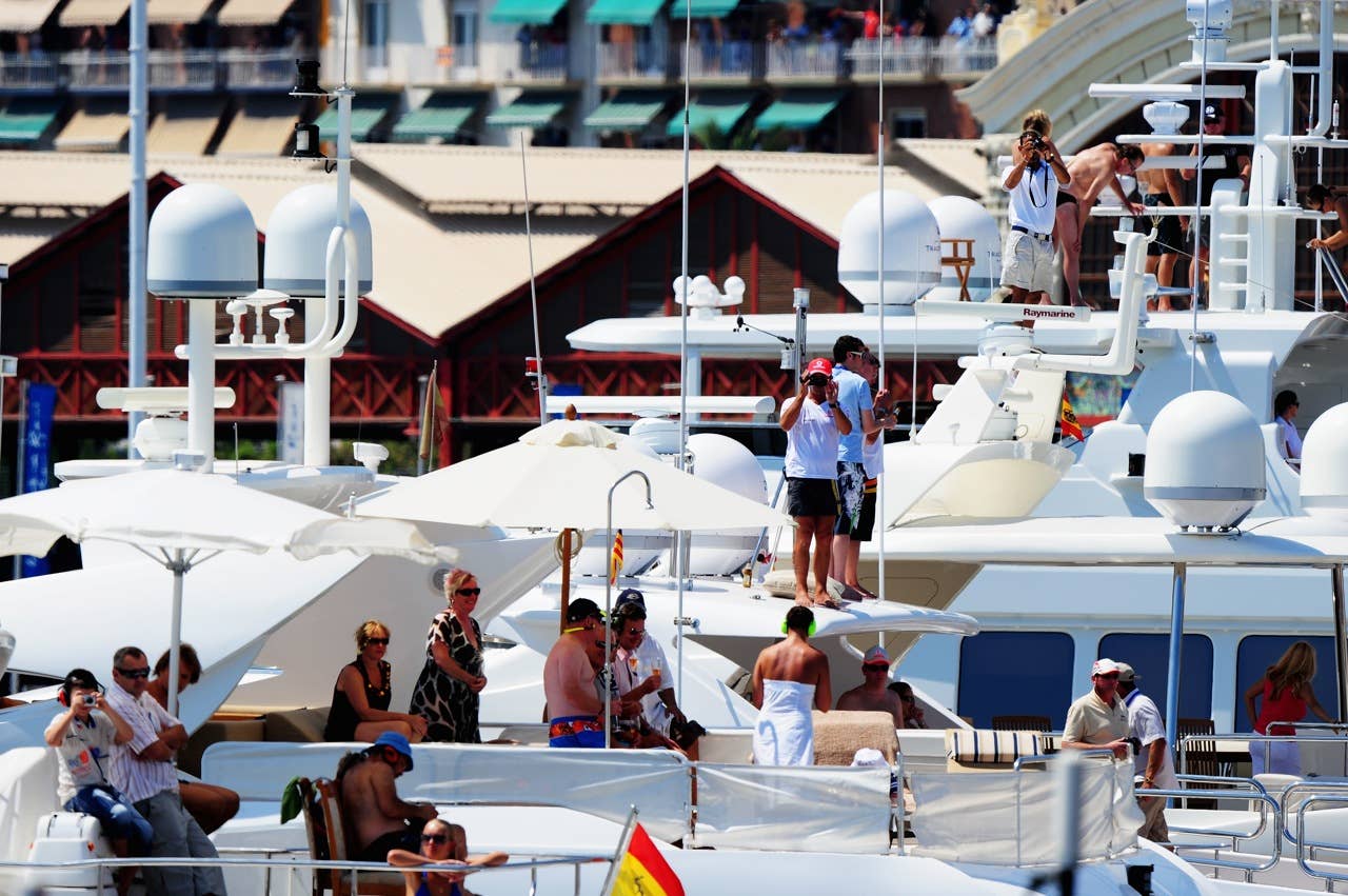 F1 Grand Prix of Europe - Race VALENCIA, SPAIN - AUGUST 23: Spectators watch from boats moored in the harbour during the European Formula One Grand Prix at the Valencia Street Circuit on August 23, 2009, in Valencia, Spain. (Photo by Clive Mason/Getty Images)