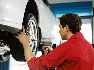 It may seem unlikely, but think of how simple it is especially if an unscrupulous mechanic thinks that the owner of the vehicle in his shop has utterly no idea what tires are on the car. Some will actual take your tires off and replace them with older tires.  Put chalk marks on the inside of your tires. Some shops will swap out your tires for older tires. If your chalk-marks are not there when you collect the car, you, and your tires, have been hustled.