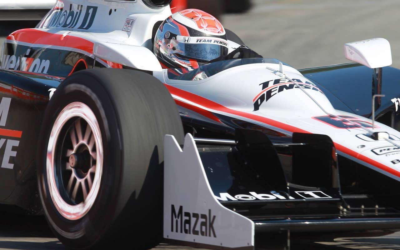 Helio Castroneves  drives on the track during a practice session for the Toronto INDY auto race in Toronto on Saturday, July 17, 2010.