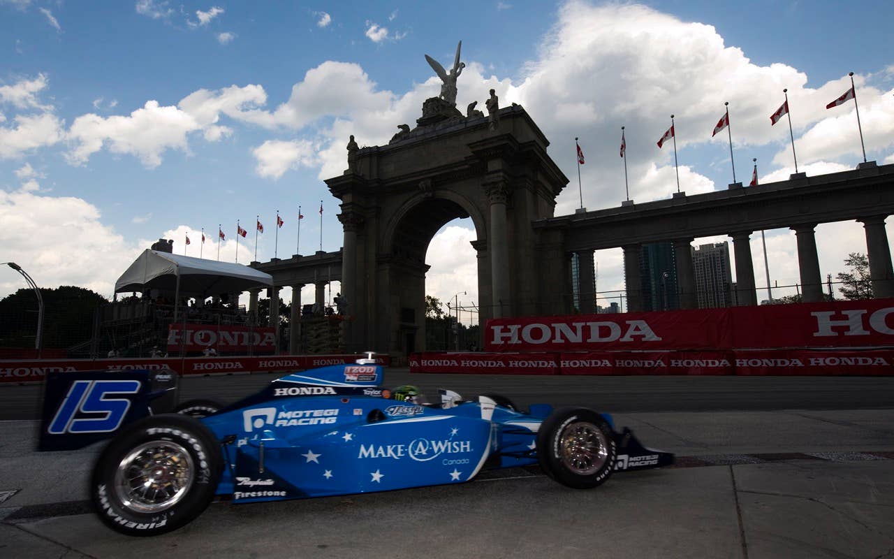 Paul Tracy of Canada drives past the Princes' Gates during qualification for the Toronto INDY in Toronto on Saturday, July 17, 2010.