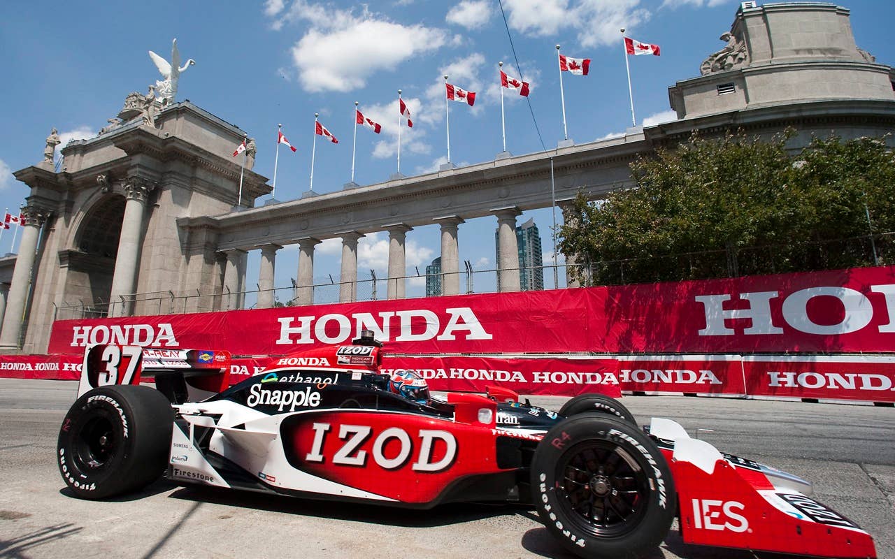 Ryan Hunter-Reaydrives in front of Prince's Gate during the second practice session for the IndyCar Series' Honda Indy Toronto auto race in Toronto on Friday July 16, 2010.
